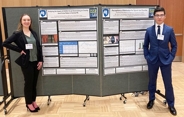 Jazzmine McCauley (Left) and Ziwei (Will) Lin show off their posters at the annual meeting for the Pennsylvania Association of Criminal Justice Educators. 