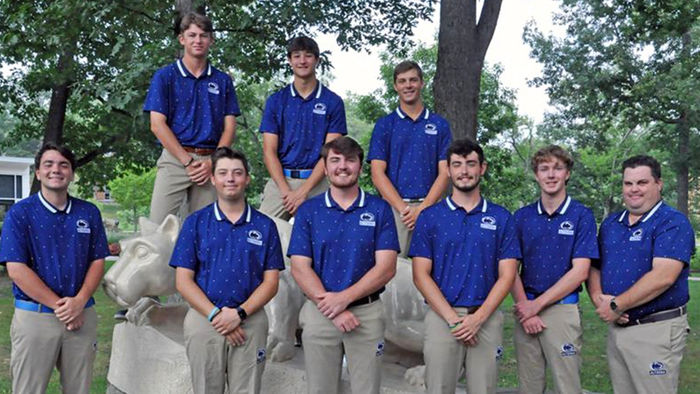 Penn State Altoona's golf team poses for team picture in front of Nittany Lion statue