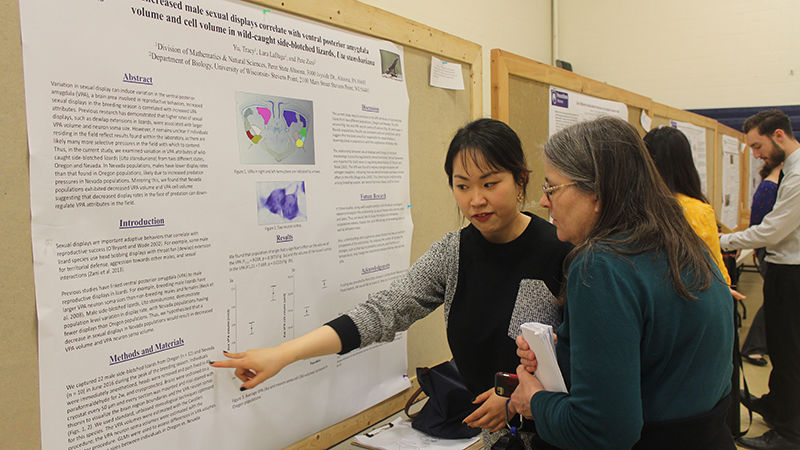 Student presenter Tracy Yu chats with Dr. Mary Kananen about her poster presentation