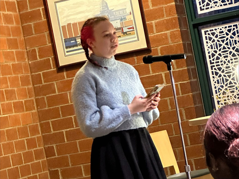 Student Emera Gregor reads a poem.