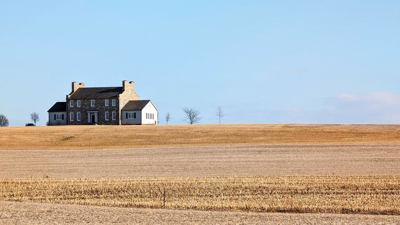 An old farmhouse in the middle of a field