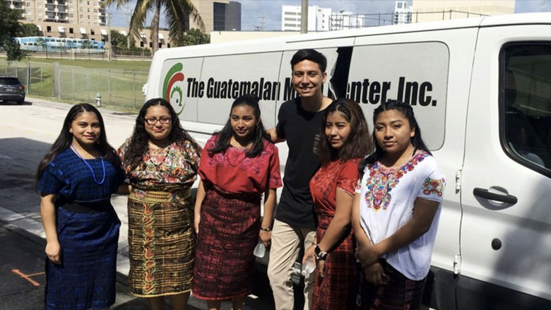 The Mayan Girls, dressed in the traditional outfits they wore to pitch to Philanthropy Tank, stand with their advisor, social worker Daniel Morgan.