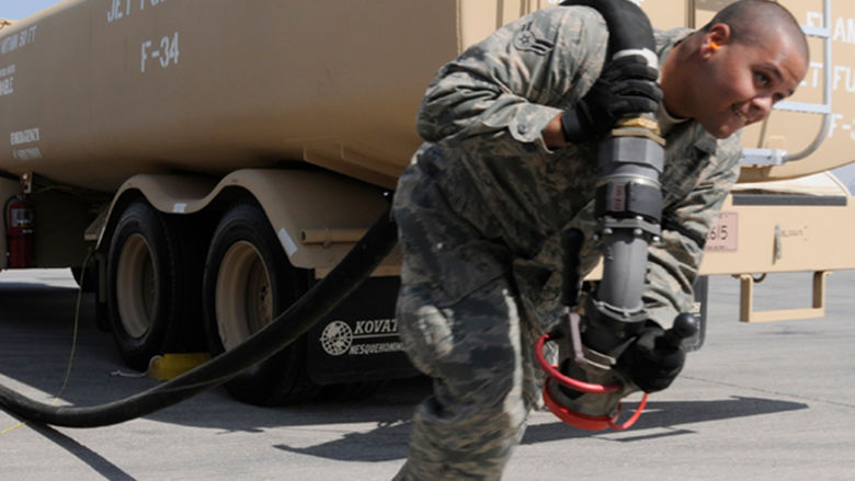Soldier hauling jet fuel hose