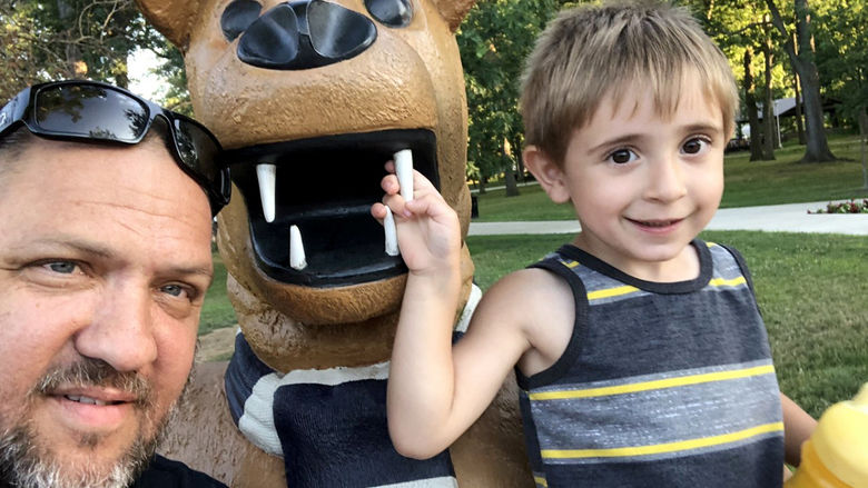 Steve Farella on campus with his youngest son, Santino.