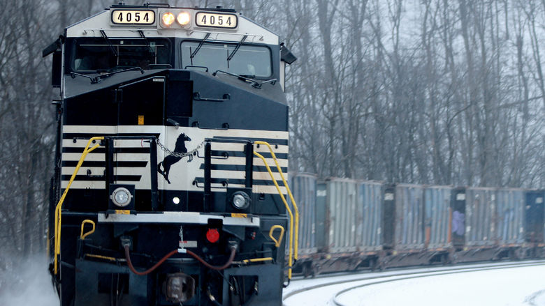 A snow-covered train making a turn on tracks