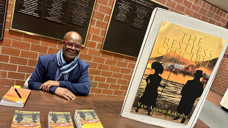 Yaw Agawu-Kakraba, professor of Spanish and African Studies, signs copies of his debut novel