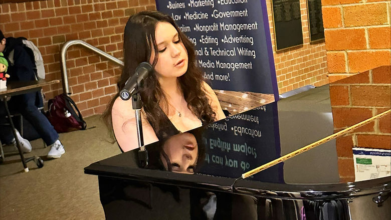 Student Maddy Colello performs a song.