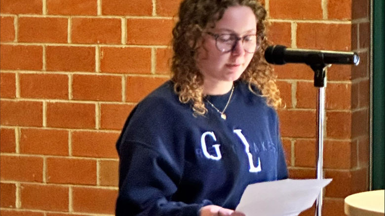 Student Abbie Woods reads her work.