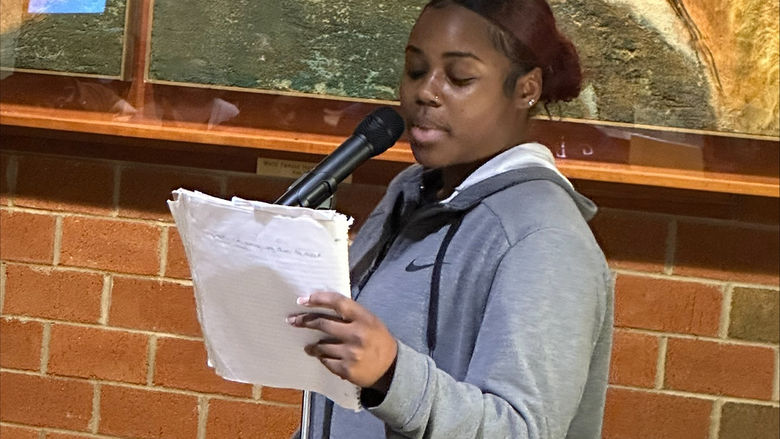 Student Nia Hubbard reads a poem.