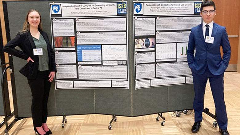 Jazzmine McCauley (Left) and Ziwei (Will) Lin show off their posters at the annual meeting for the Pennsylvania Association of Criminal Justice Educators. 