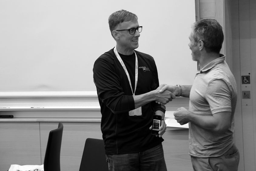 Peter Hopsicker (left) is congratulated by Dr. Alun Hardman, presdient of the IAPS