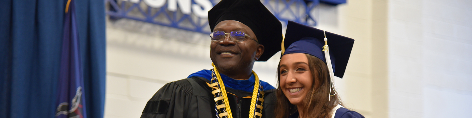Penn State Altoona Chancellor Ron Darbeau poses with a graduate at the spring 2025 commencement ceremony