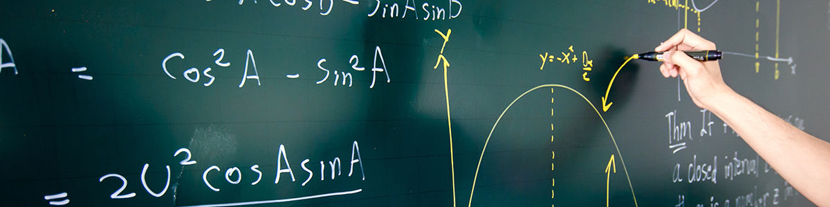 Stock photo of someone solving a math equation on a board