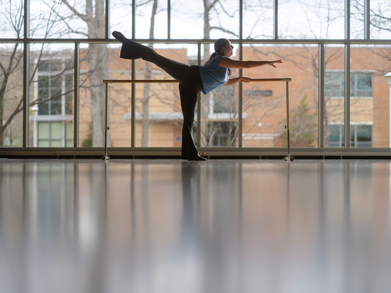 A student dancer warming up in the Penn State Altoona dance studio