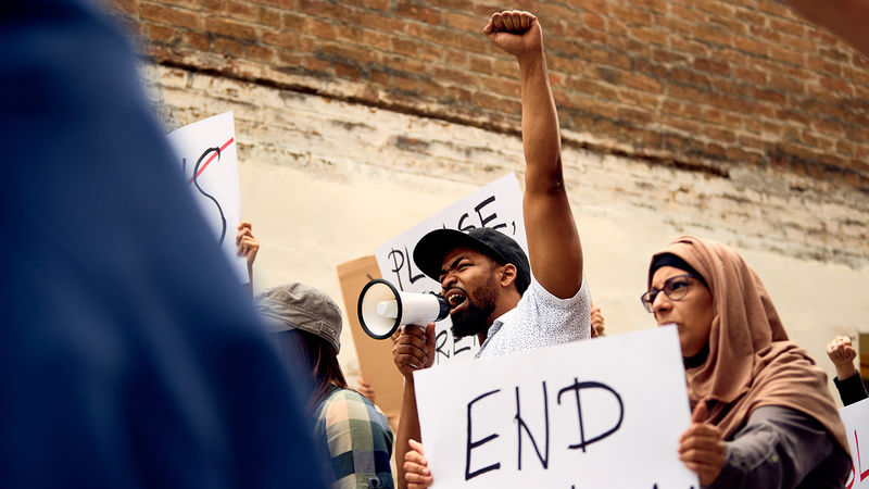 A group of diverse individuals protest racism