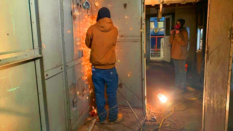 Calvin Spector (front) and Garret Blum (background) work in the caboose at the Altoona Railroader’s Memorial Museum