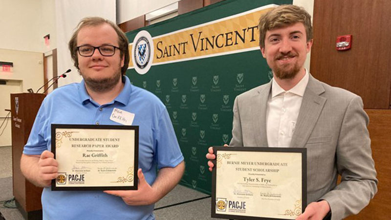Rae Griffith (left) and Tyler Frye show off their awards from the Pennsylvania Association of Criminal Justice Educators conference.