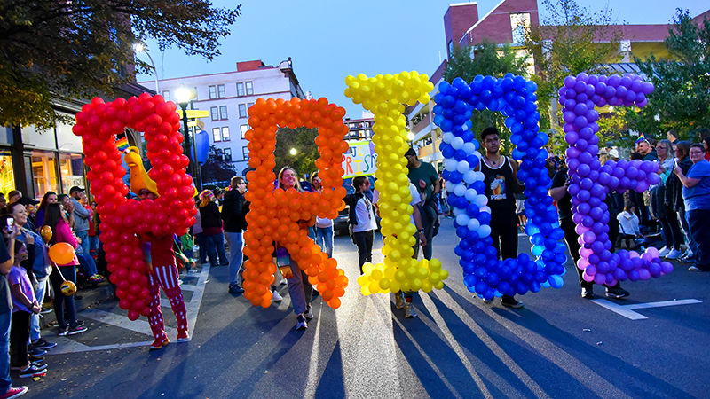 Students hold up balloons spelling Pride at the Penn State Altoona Pride Parade
