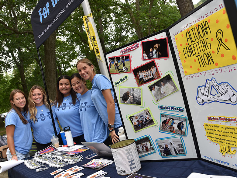 Female students at the THON booth during the Involvement Fair