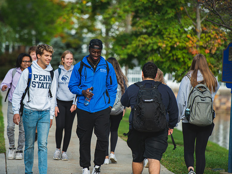 A diverse group of students walking on campus