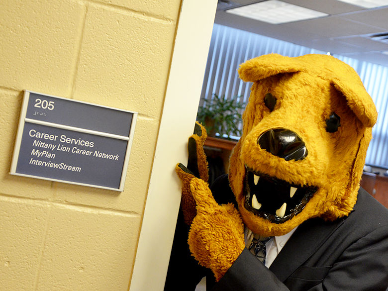 Nittany Lion mascot pointing at a career services sign