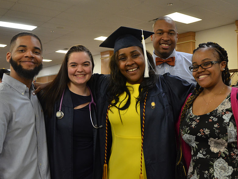 A family poses for a photo at spring 2018 commencement
