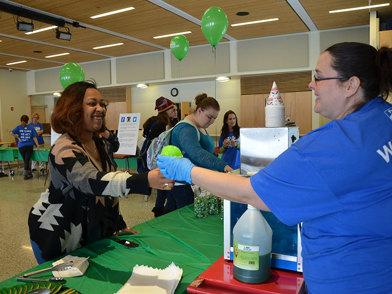 Maria Mosley serving treats at an event on campus
