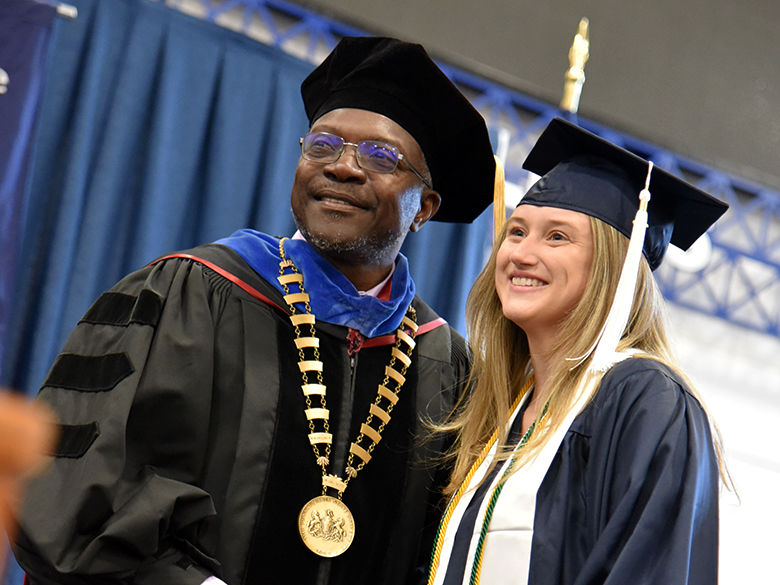 Chancellor Ron Darbeau congratulating a student at graduation