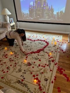 Beth Strange arranges rose petals in the shape of a heart