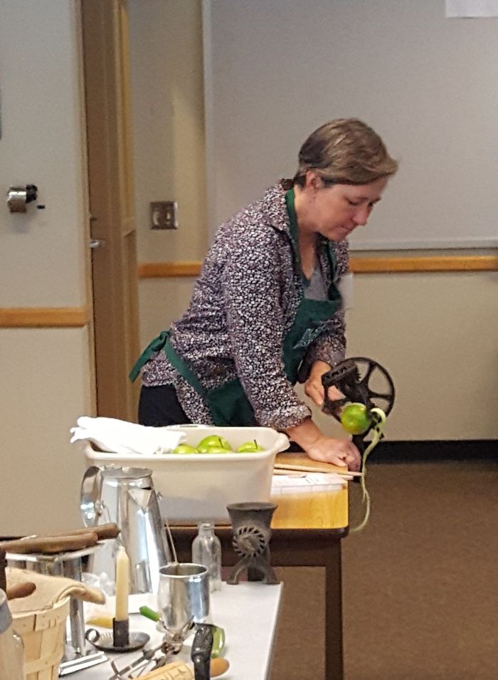 Rita Graef, curator of the Pasto Agricultural Museum, demonstrates a late 19th-century apple peeler