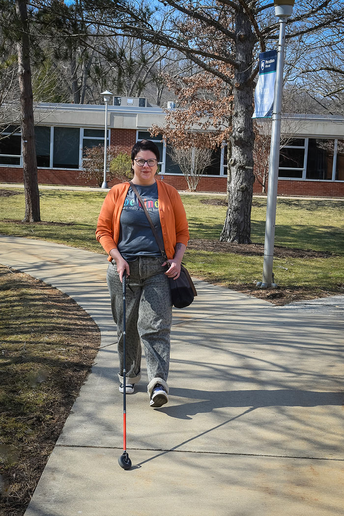 Parrish never leaves home without her mobility cane and navigates campus with its assistance.