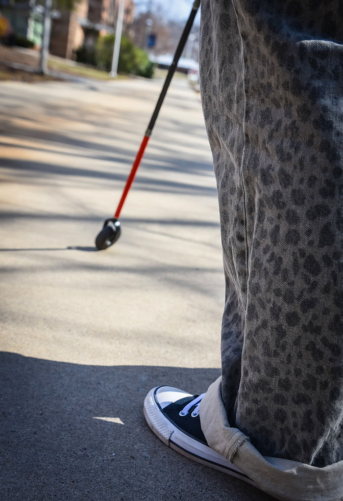 Parrish navigates campus with the help of her mobility cane.