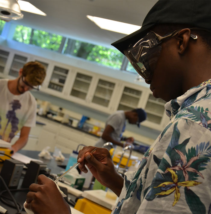 Students work in a chemistry lab on campus
