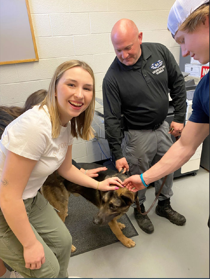 Third-year criminal justice student Lacee Barnhart learns about the PSP K9 unit