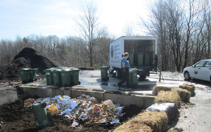 Student James Edwards helps unload food waste at the Ashville compost facility.