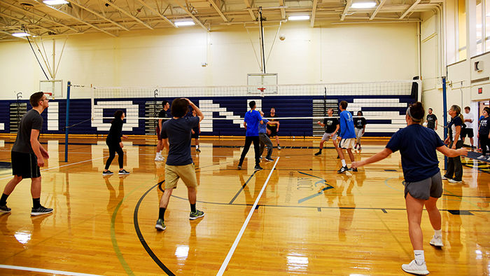 Kinesiology students playing volleyball in the arena
