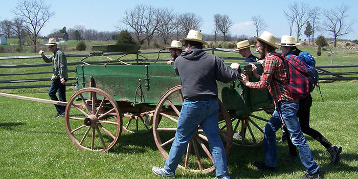 History students pushing a wagon