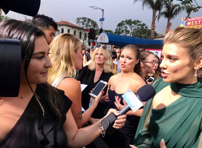 Rivera Chardon interviews celebrities during the Mile 22 premiere for Acceso Total