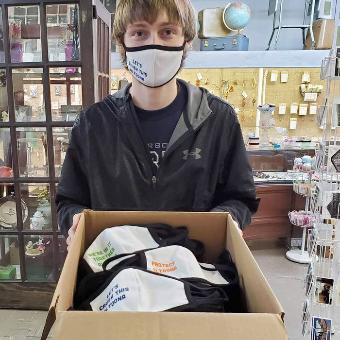 Joey Roesch shows off a box of face masks created for the Mask Up Altoona program.