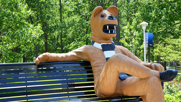 Statue of the Nittany Lion seated on a bench