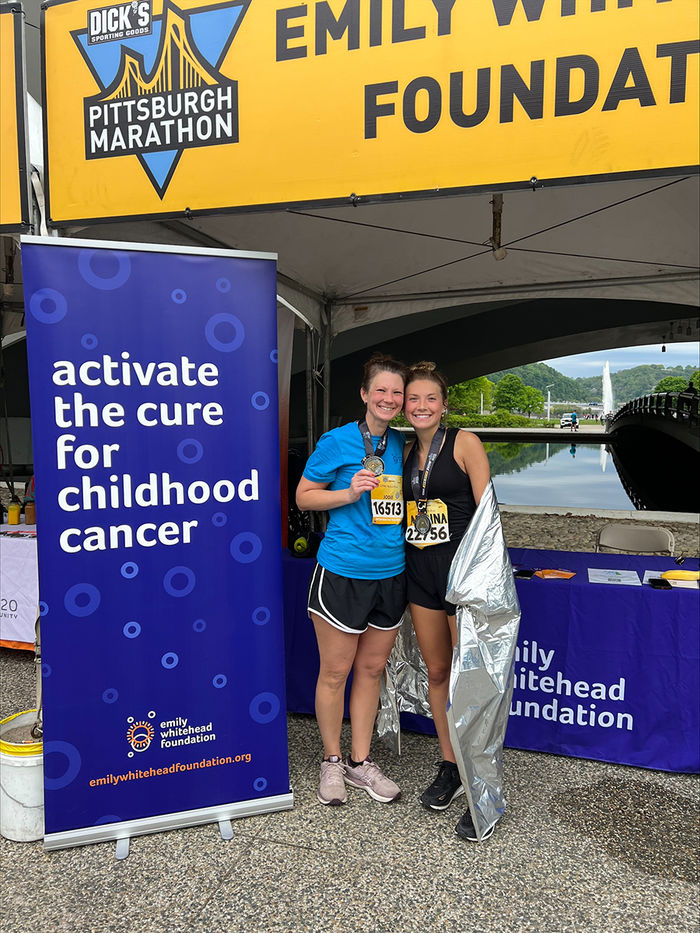 Manna Potter and her mother, Jodie, at the 2023 Pittsburgh Half Marathon in front of the Emily Whitehead Foundation information booth