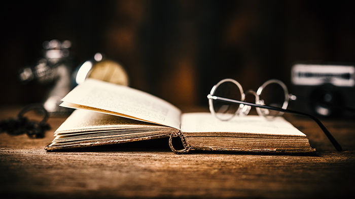 Glasses laying on an old book