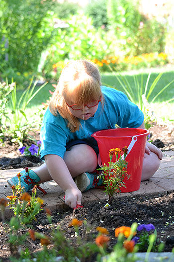 A child plays in the Sensory Garden