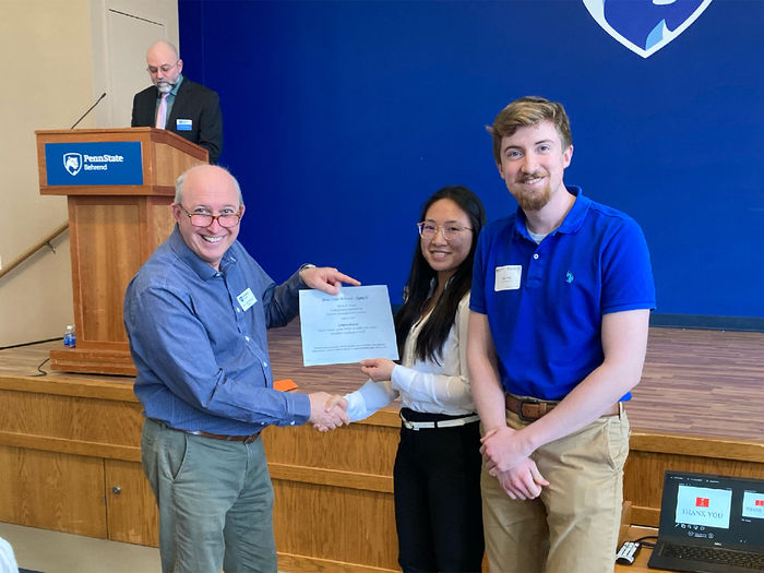 Tyler Frye and Rachel Kosaka receiving an award at the spring 2022 Undergraduate Research and Creative Accomplishment Conference