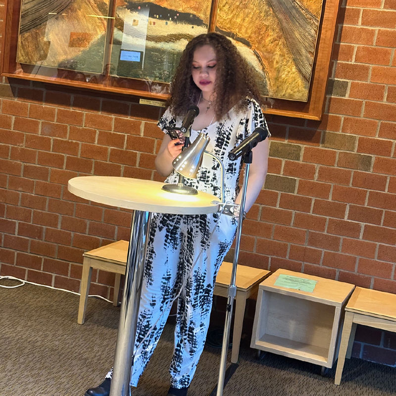 Student Emera Gregor reads an original short story