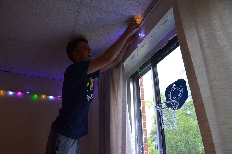 A student decorates their residence hall room