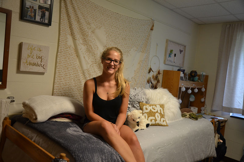 First-year student relaxes in her newly-decorated residence hall room