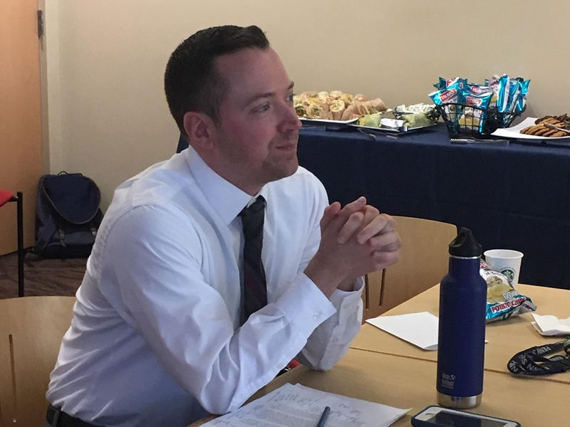 A faculty member observes senior English seminar presentations