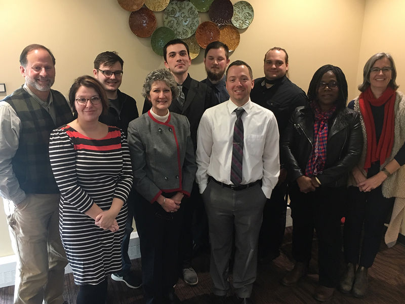 English faculty and seniors pose together following seminar presentations