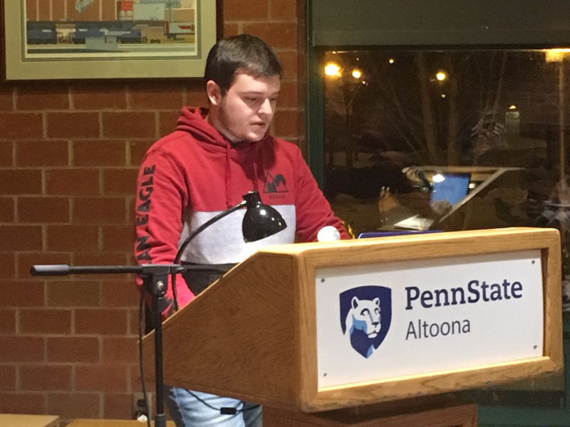 A student reading at the spring 2019 Hard Freight Cafe